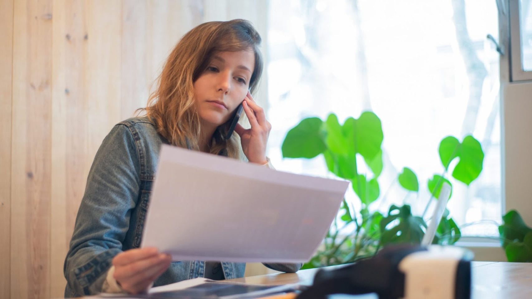 Woman calling for an update while reviewing paperwork about a pending death certificate in Texas.