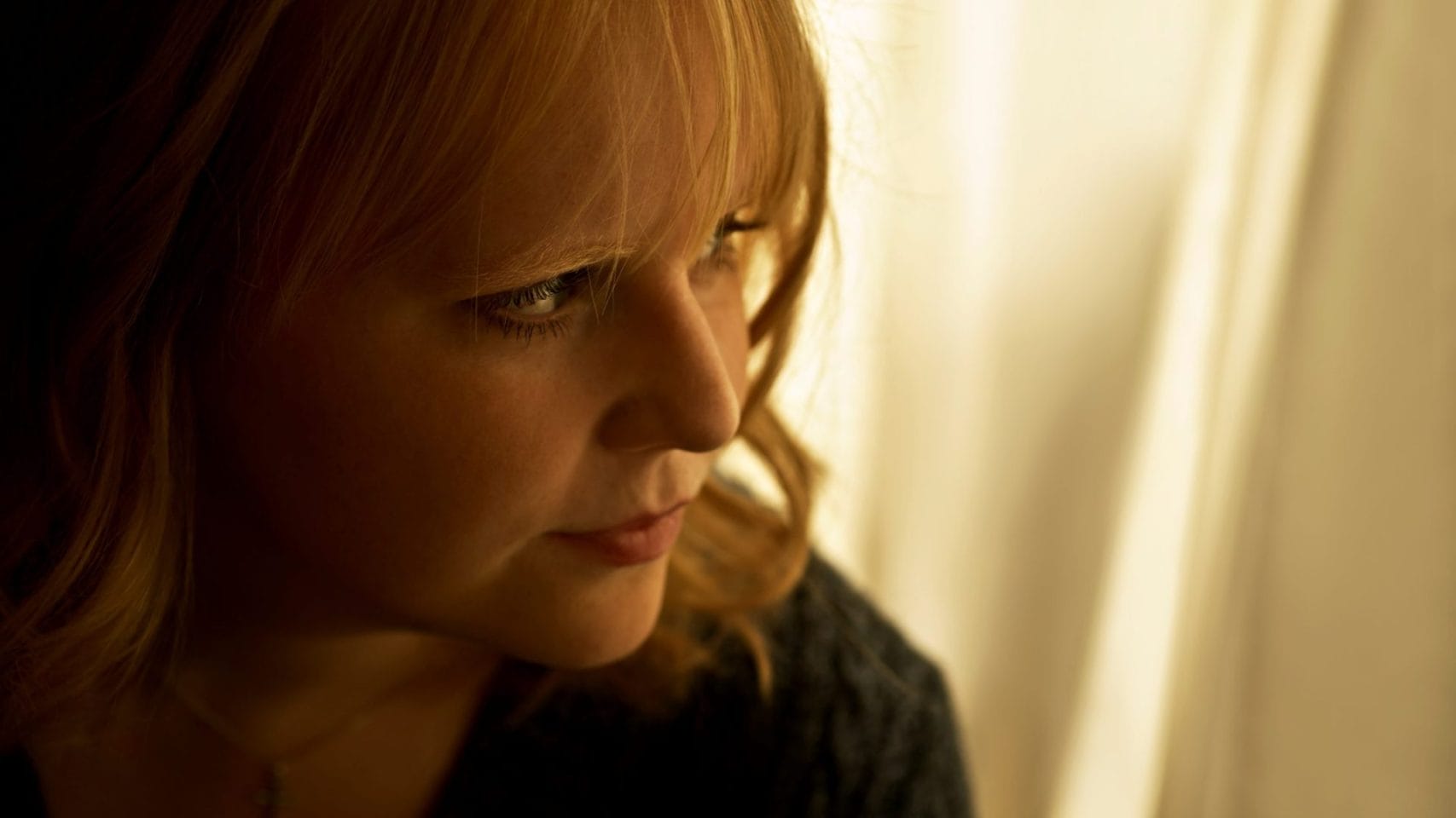 Woman in quiet reflection while considering witnessing cremation in Houston.