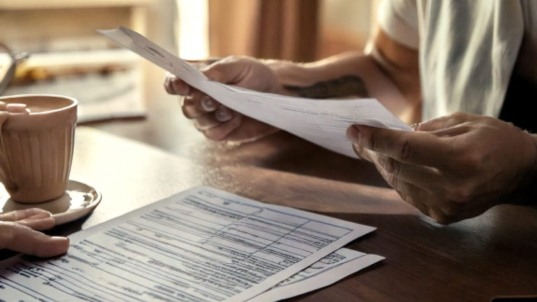 Family reviewing multiple copies of official paperwork related to a pending death certificate in Texas.