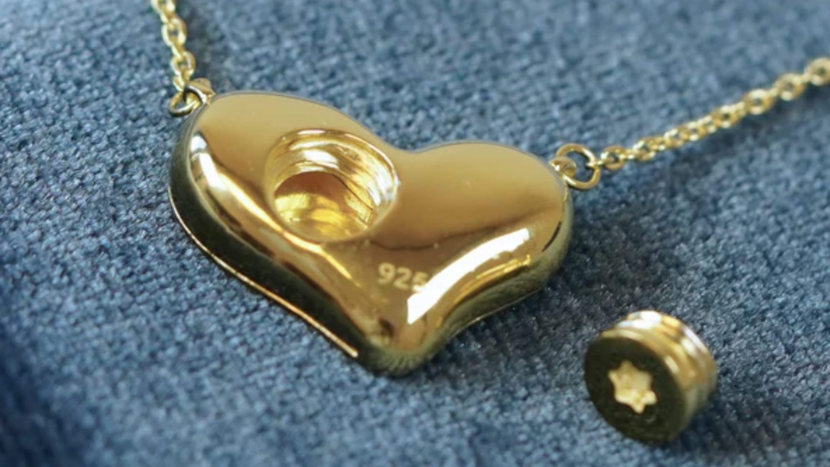Heart-shaped cremation jewelry pendant with an open compartment for ashes.