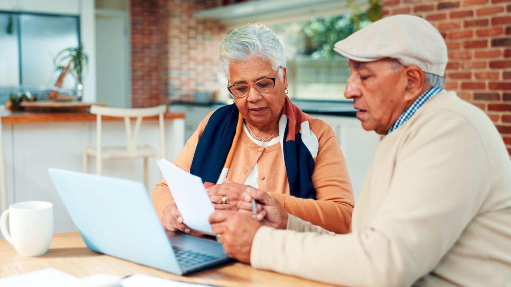 Couple reviewing paperwork and online cremation pricing information for direct cremation services in Galveston, TX.