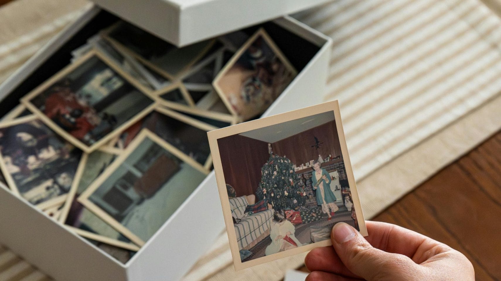 Family member holding cherished photographs representing personalized memorial options after cremation in Humble, TX