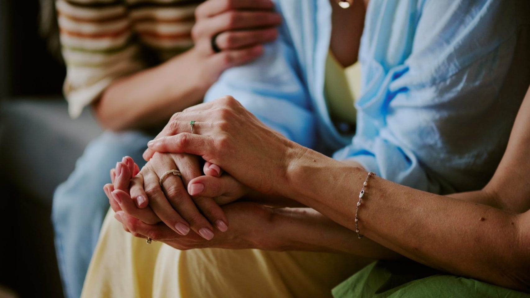Family members holding hands for comfort before witnessing cremation in Houston.