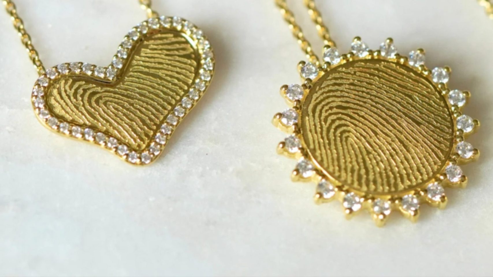Gold fingerprint necklaces designed to hold ashes as personalized memorial keepsakes.