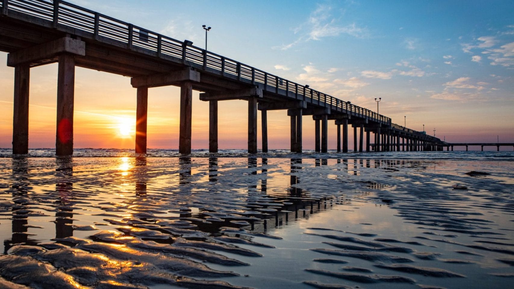 Galveston Gulf Coast pier at sunrise, reflecting the peaceful coastal setting where families may gather for remembrance after cremation.