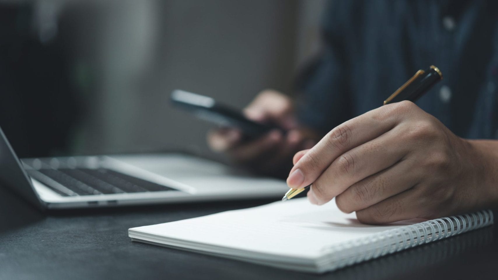 Person writing notes to gather documents needed for cremation arrangements in Houston Texas
