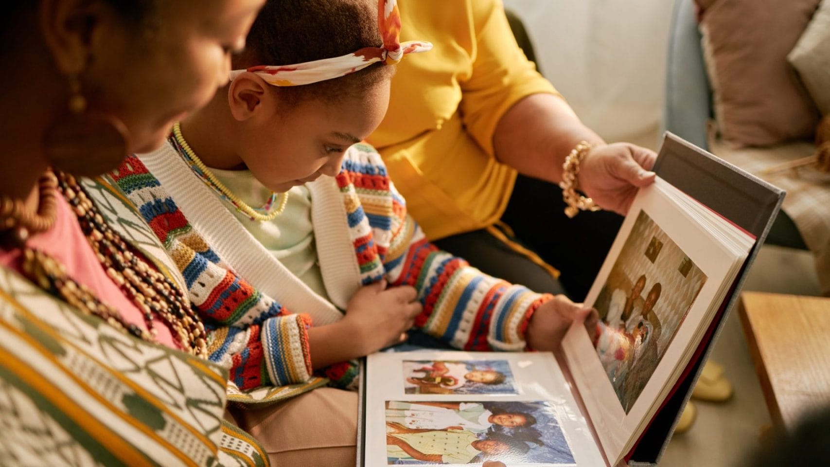 Family looking through photo albums while gathering memories for an obituary.