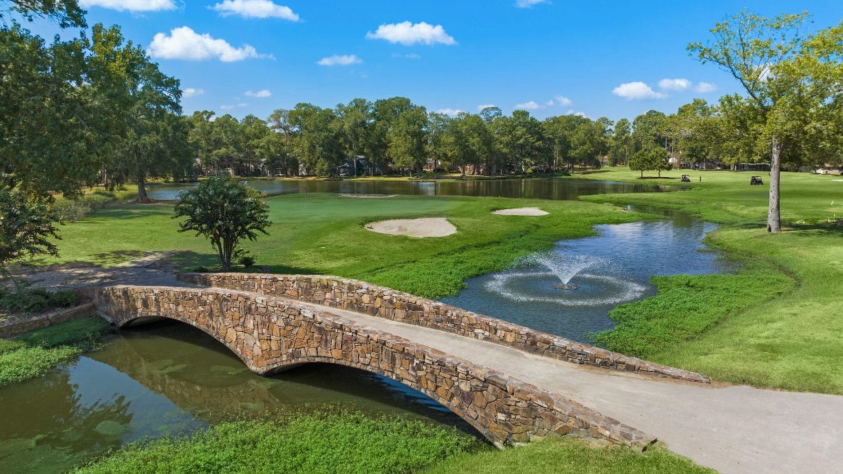Stone bridge and landscaped grounds at Enclave at Newport in Crosby, Texas.