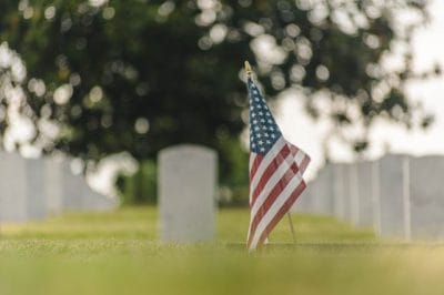 American flag placed beside a veteran’s grave for Memorial Day remembrance in Houston