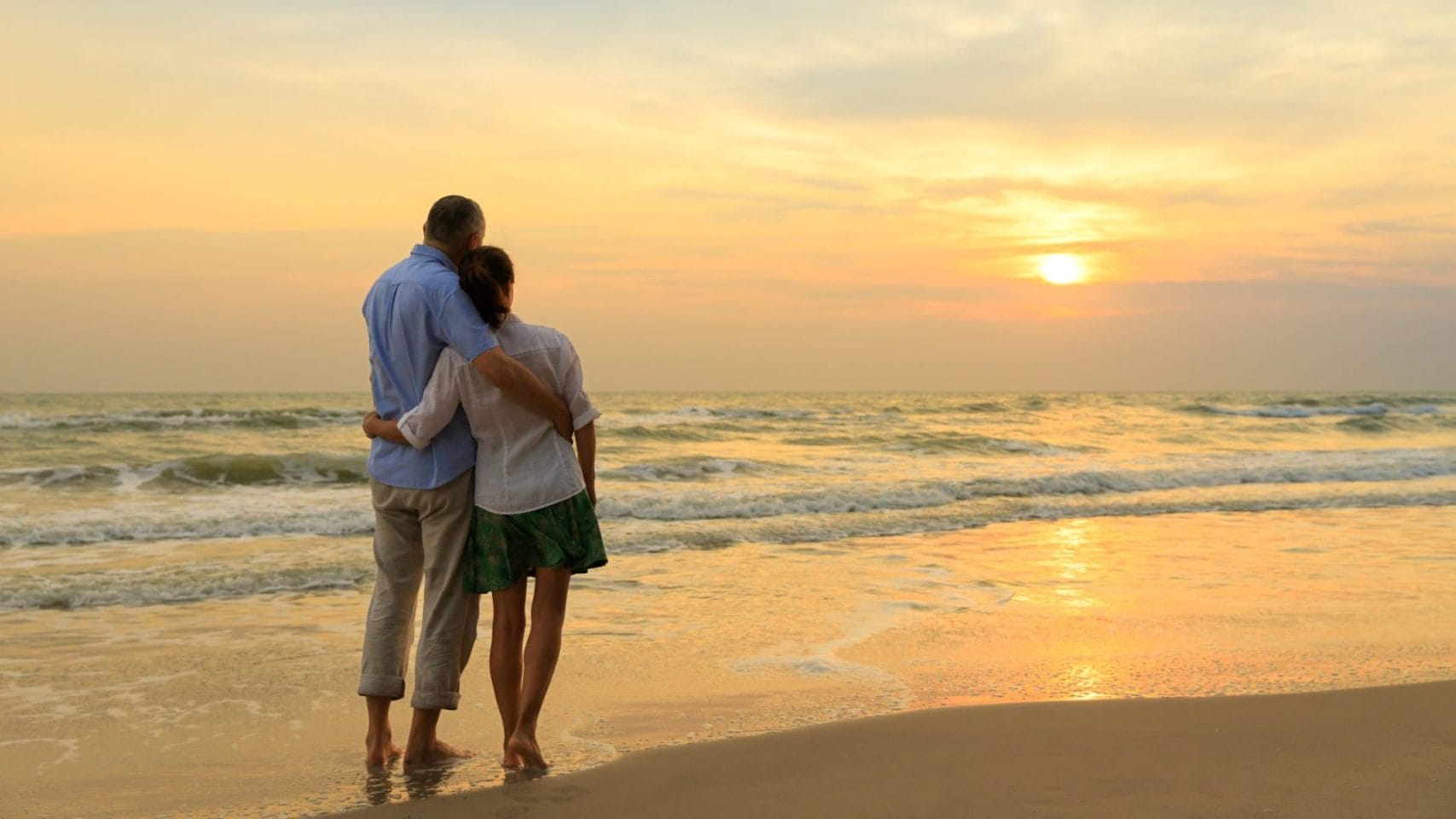 Couple standing together by the water after cremation services