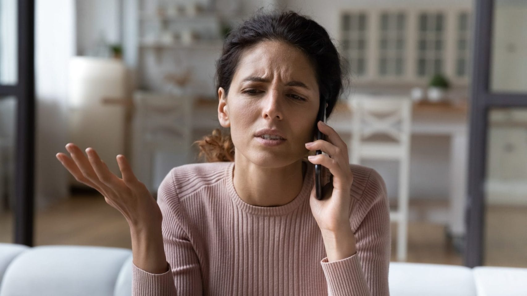 Woman receiving a call from the medical examiner in Houston.