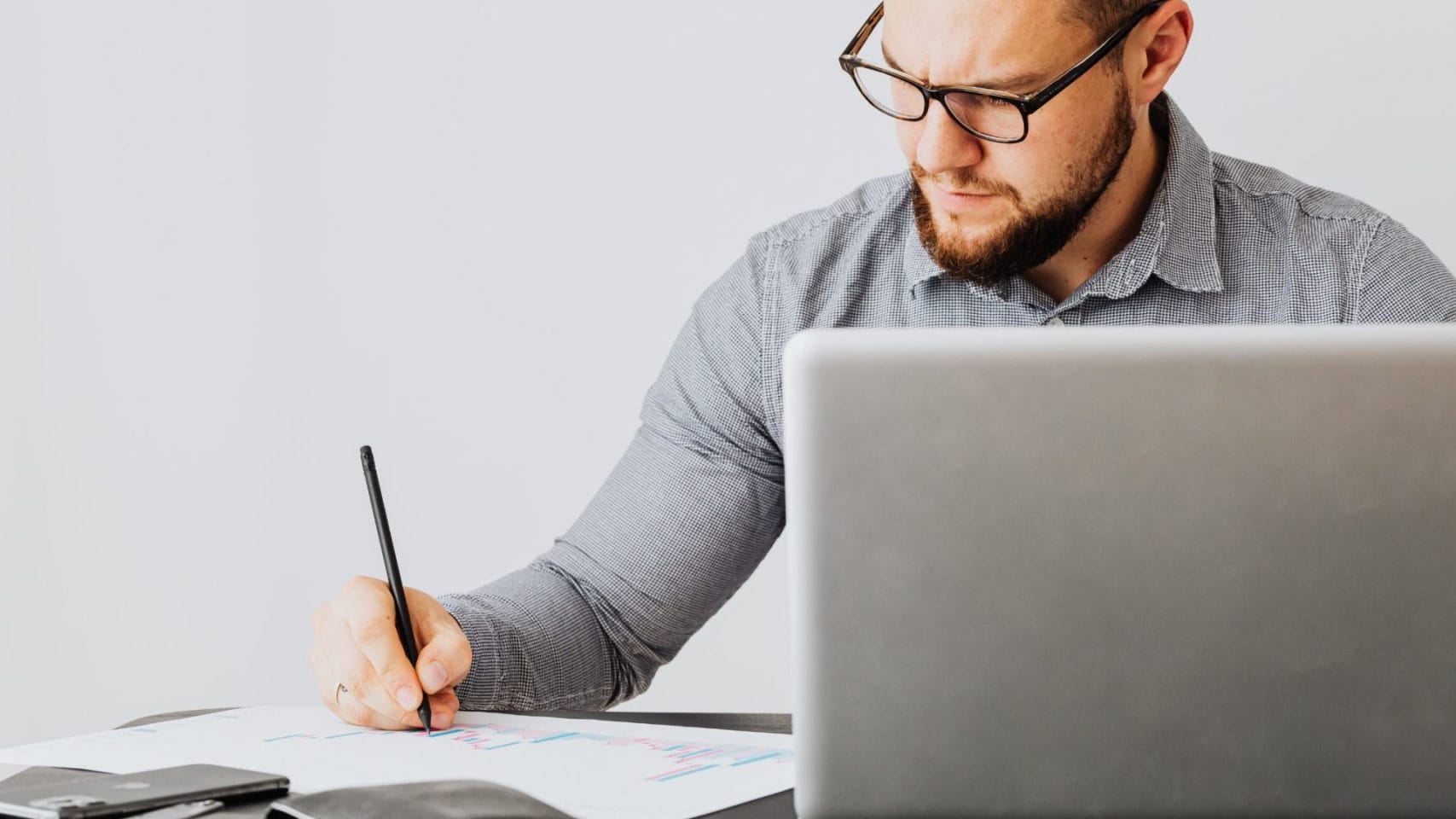 Person reviewing documents and using a laptop after a death in Houston