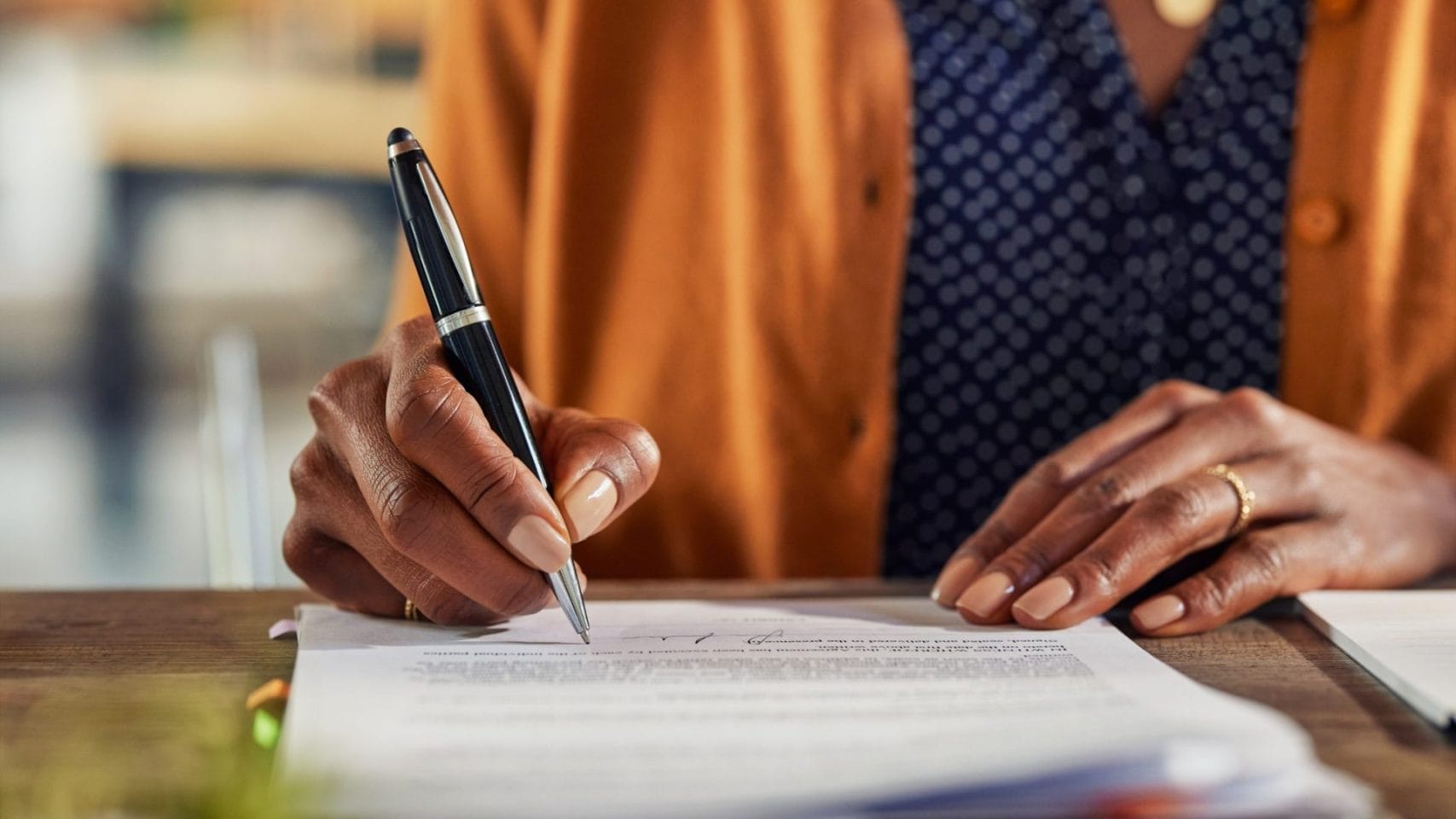 Person signing cremation authorization forms for arrangements in Houston Texas