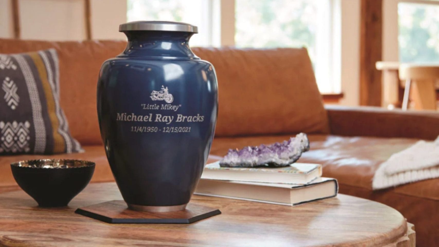 Standard adult urn displayed on a table in a peaceful home setting.
