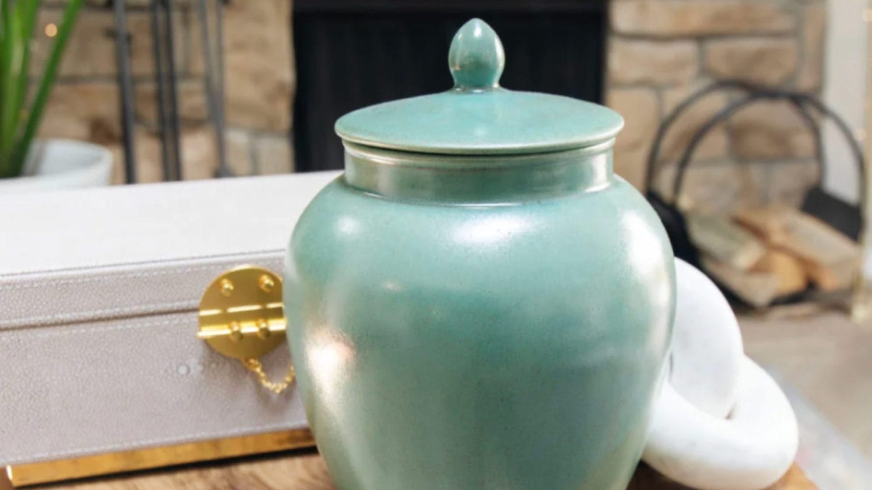 Traditional green urn displayed in a peaceful home setting.
