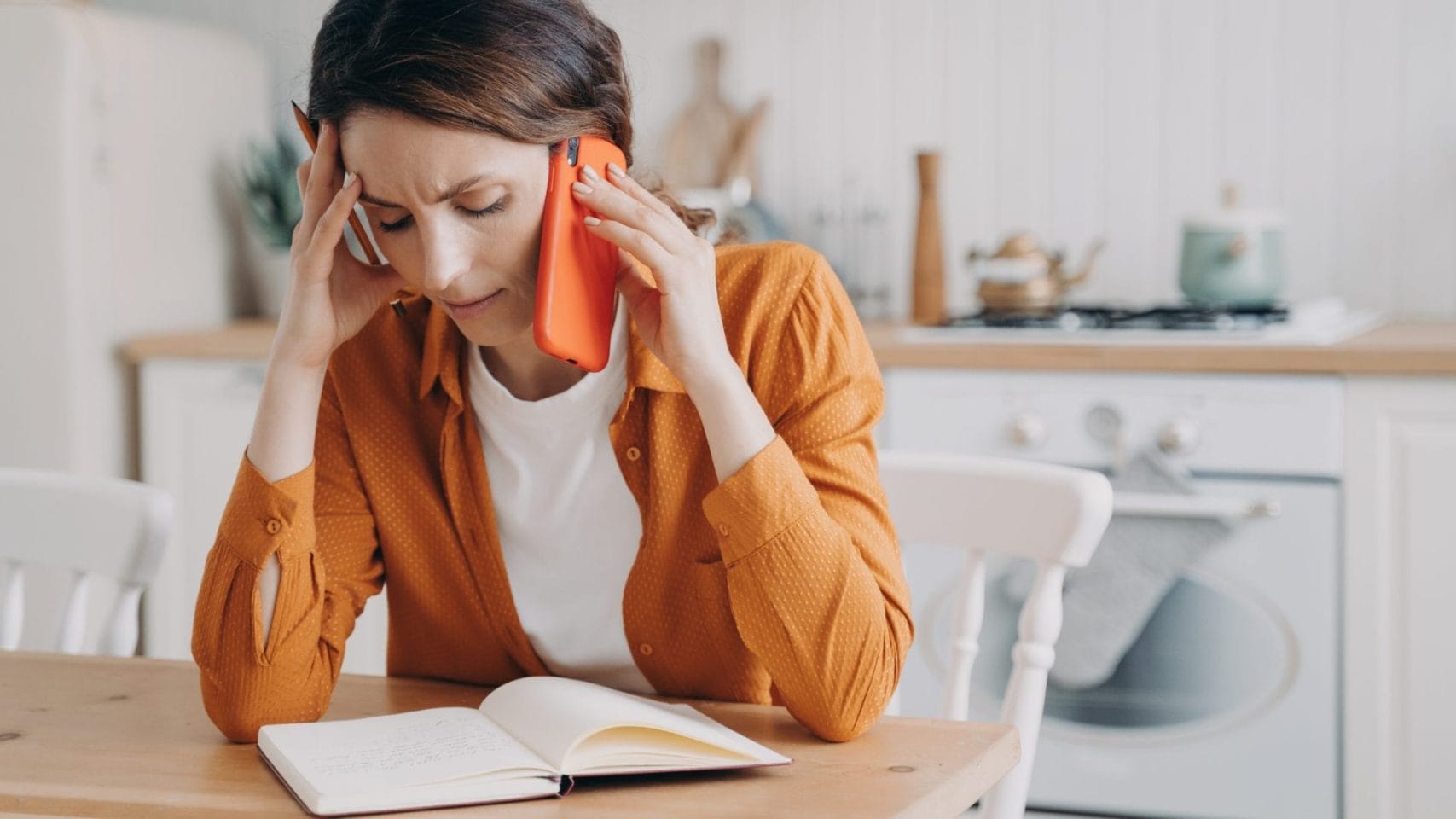 Woman on the phone reviewing notes after a death in The Woodlands, TX.