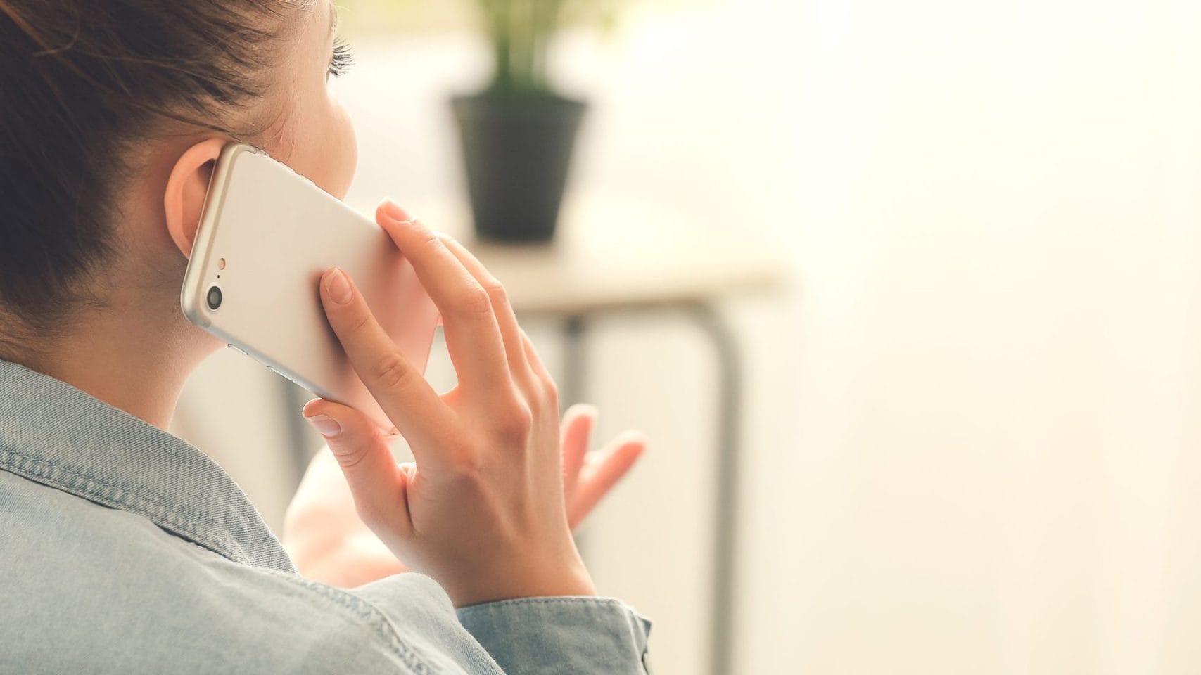 Woman on the phone getting help with cremation services in Rosenberg TX after a loved one dies.