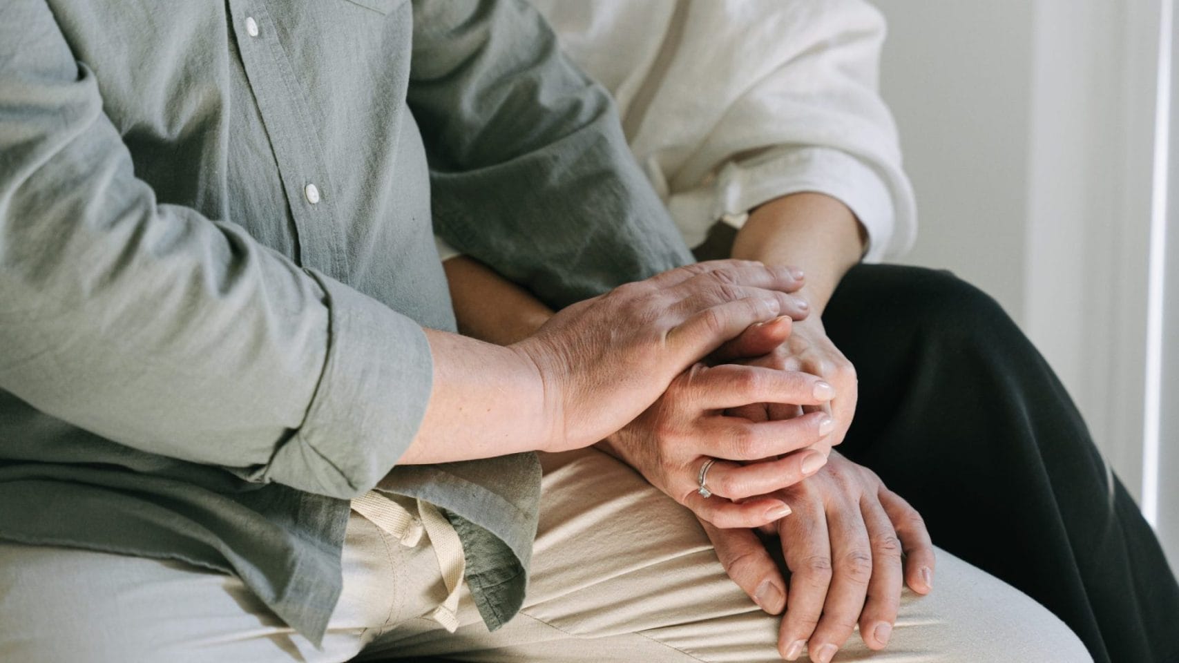 Family holding hands at home while learning what to do after a death in Rosenberg Texas.