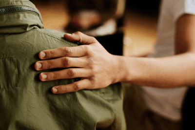 Hand of young supportive man consoling an adult